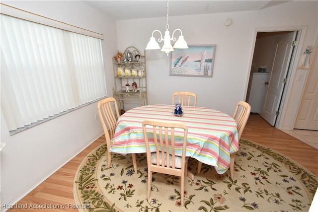 dining room with a notable chandelier and light hardwood / wood-style floors