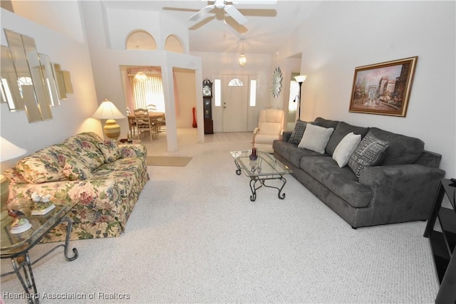 living room with carpet flooring, high vaulted ceiling, and ceiling fan