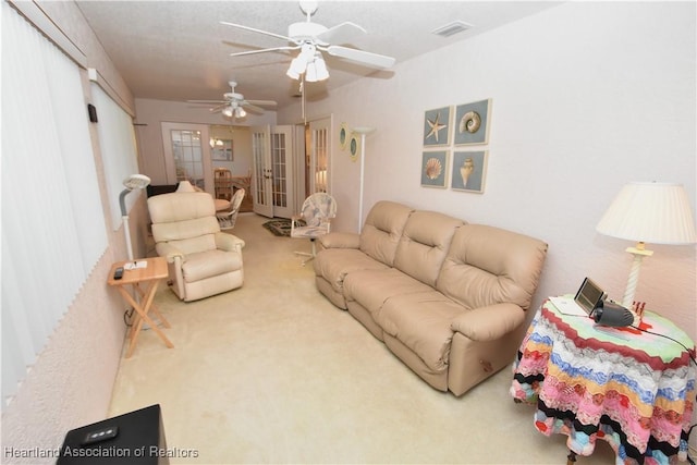 living room with ceiling fan and carpet