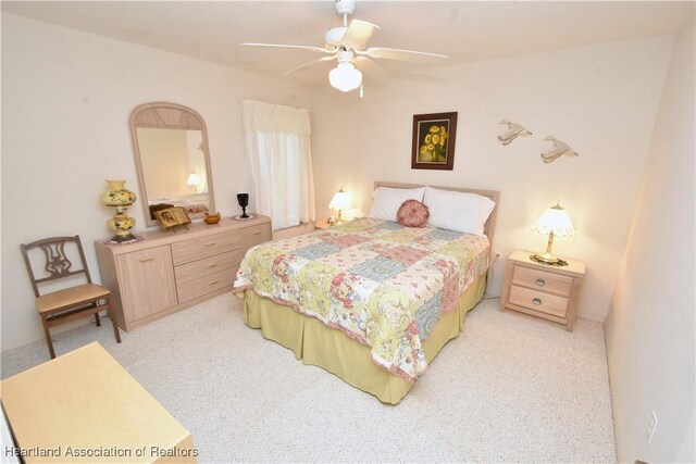 bedroom with light carpet and ceiling fan