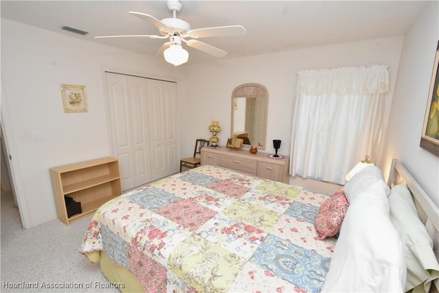 carpeted bedroom featuring a closet and ceiling fan