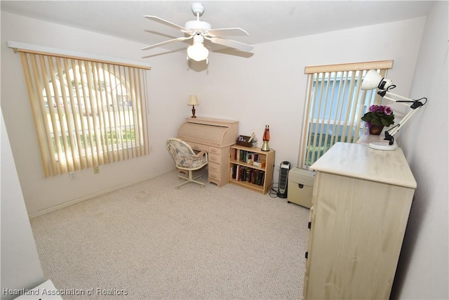 interior space featuring light carpet and ceiling fan