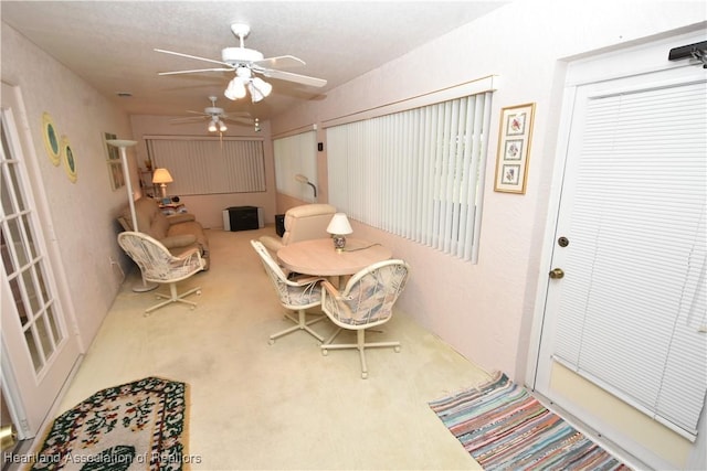 carpeted dining area featuring ceiling fan