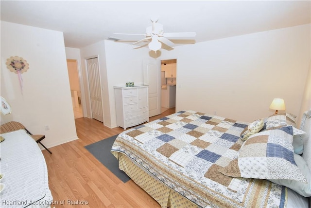 bedroom featuring a closet, light hardwood / wood-style flooring, and ceiling fan