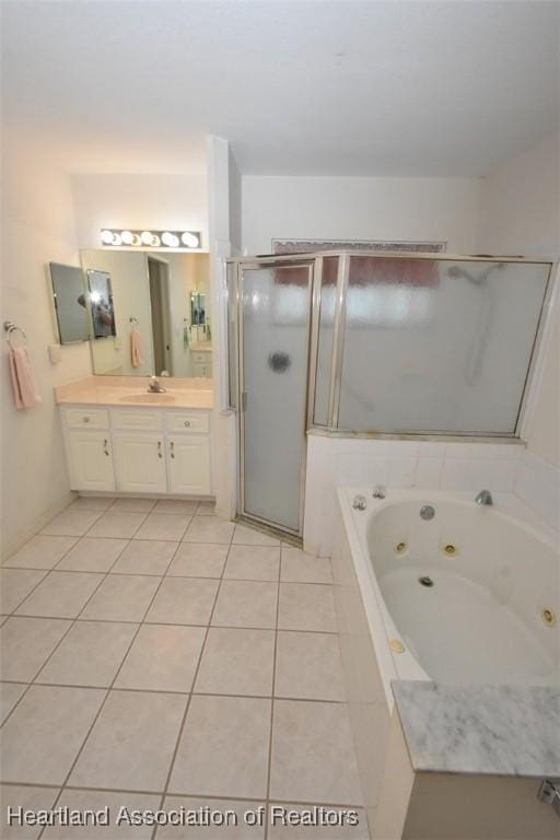 bathroom with plus walk in shower, vanity, and tile patterned floors