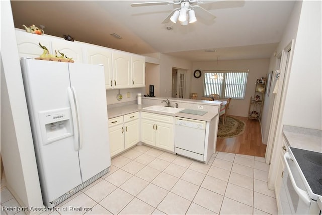 kitchen featuring kitchen peninsula, sink, light tile patterned flooring, and white appliances