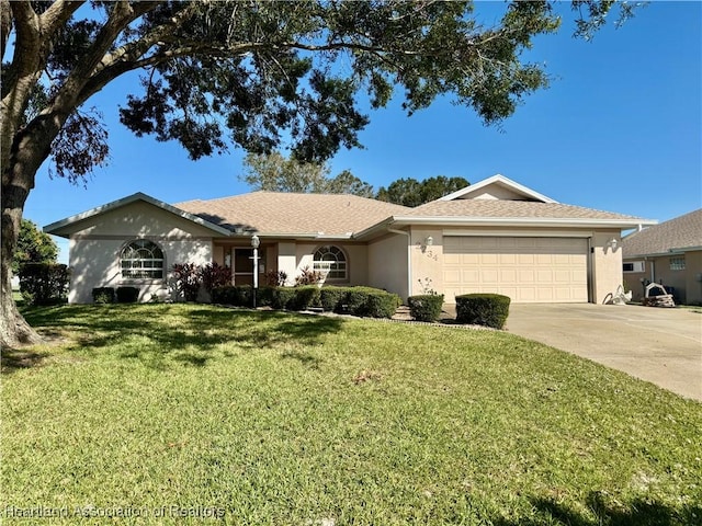 single story home with a garage and a front lawn