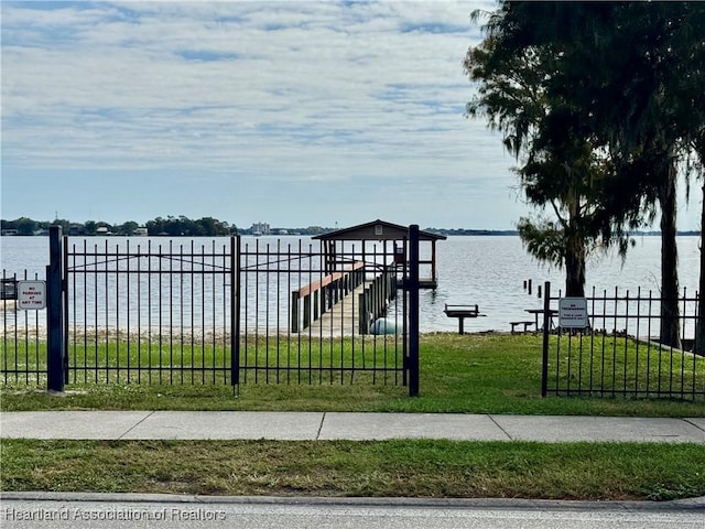 exterior space featuring a water view and a lawn