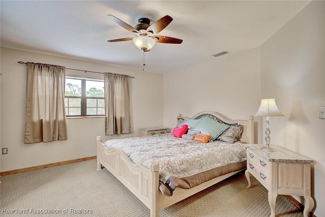 bedroom with a ceiling fan, light colored carpet, visible vents, and baseboards