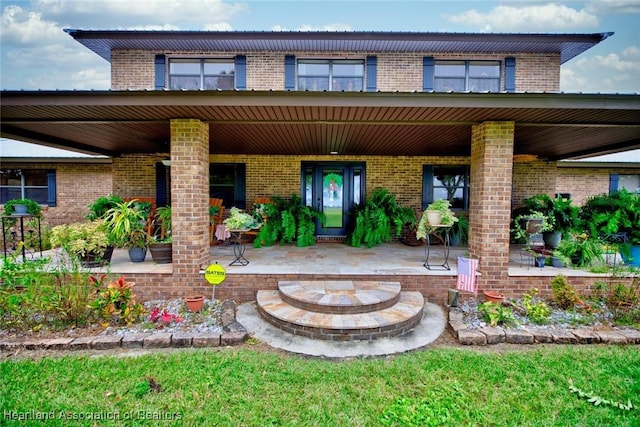 exterior space featuring an outdoor fire pit and brick siding