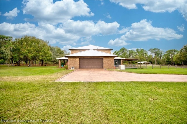 exterior space featuring an attached garage, brick siding, fence, concrete driveway, and a front yard