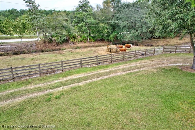 view of yard featuring a rural view and fence