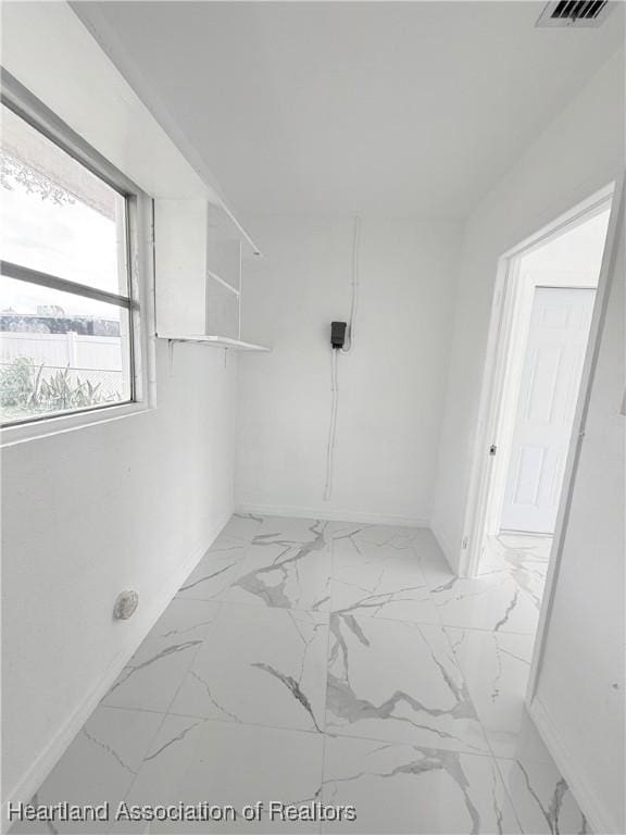 unfurnished room featuring marble finish floor and visible vents