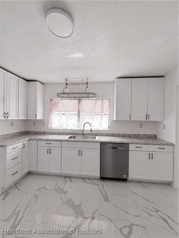 kitchen with marble finish floor, light countertops, white cabinets, a sink, and dishwasher