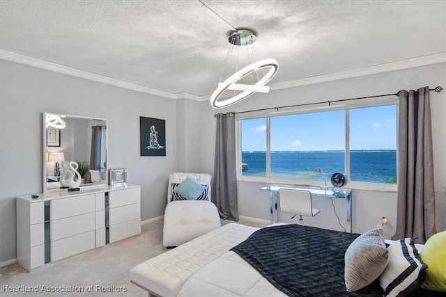 carpeted bedroom featuring a textured ceiling, ornamental molding, a water view, and a notable chandelier