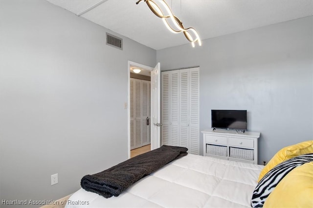 bedroom with a closet and visible vents