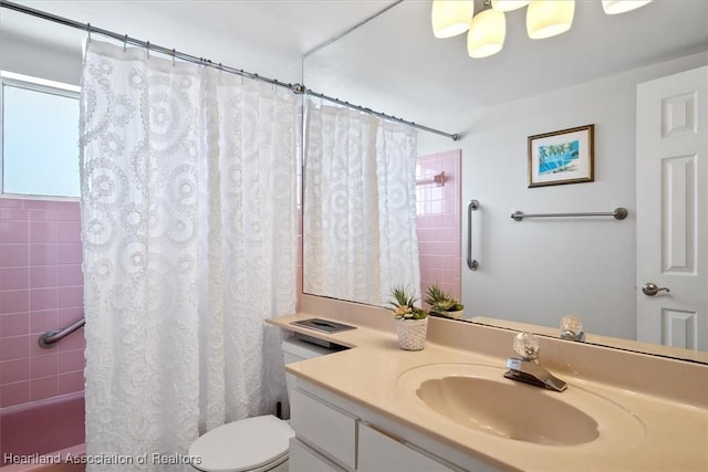 bathroom with toilet, shower / bath combination with curtain, and vanity