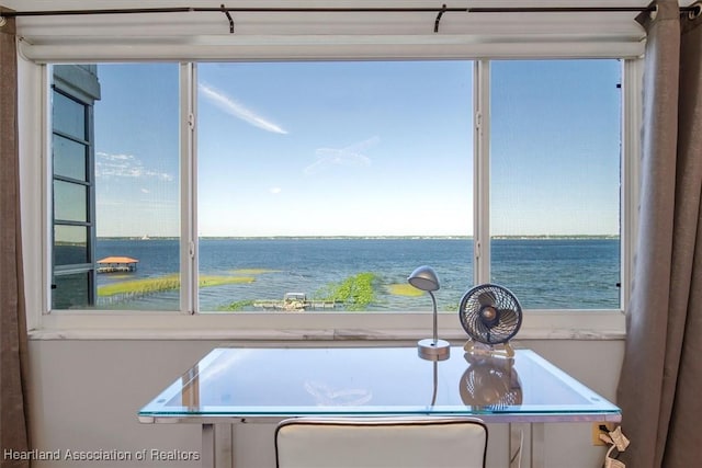 interior space with plenty of natural light and a water view