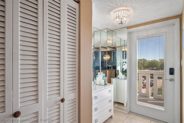 interior space with a notable chandelier and light tile patterned floors