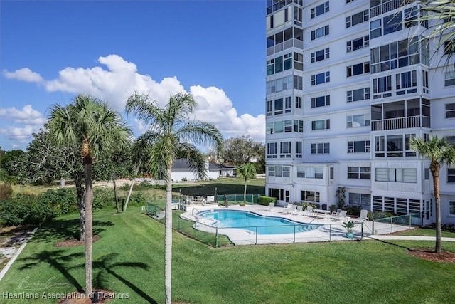 pool with a lawn and a patio