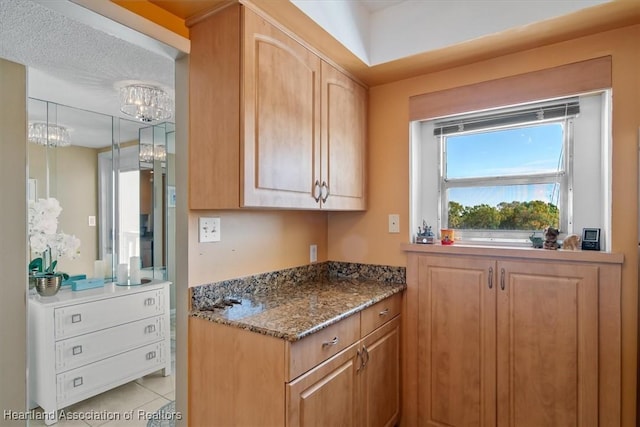 kitchen with stone countertops and light tile patterned flooring