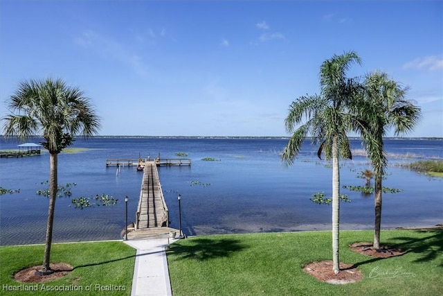 dock area featuring a yard and a water view