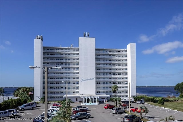 view of building exterior featuring uncovered parking