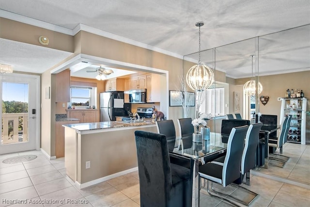 dining room featuring ceiling fan with notable chandelier, ornamental molding, and light tile patterned floors