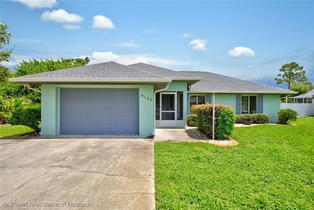 ranch-style house with roof with shingles, stucco siding, a front yard, a garage, and driveway