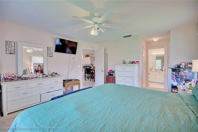 bedroom featuring visible vents, ceiling fan, and ensuite bathroom