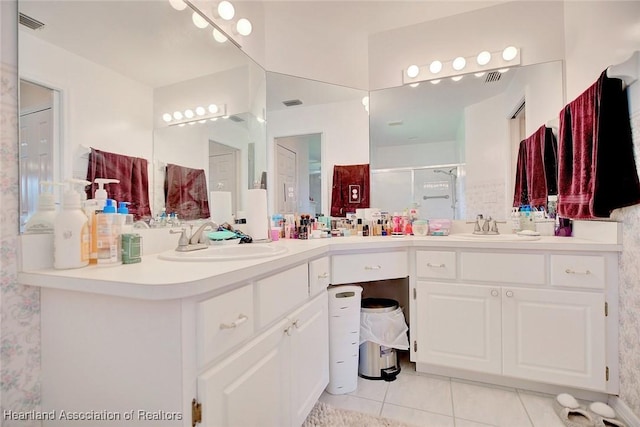 full bath featuring a stall shower, visible vents, vanity, and tile patterned floors