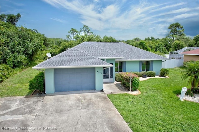 ranch-style house featuring a garage, a shingled roof, driveway, stucco siding, and a front yard