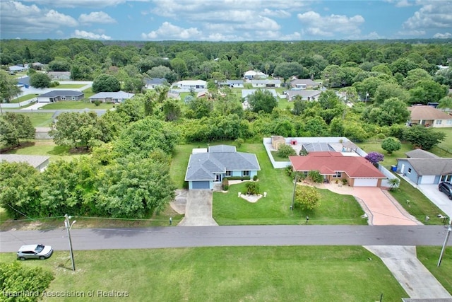 aerial view featuring a forest view and a residential view