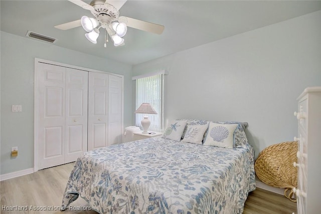 bedroom with a ceiling fan, a closet, visible vents, and light wood-style floors