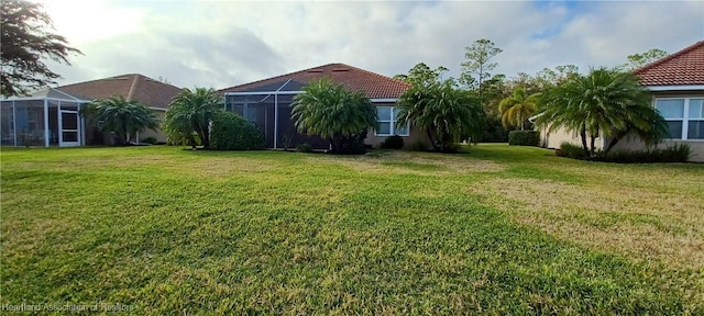 view of yard featuring glass enclosure