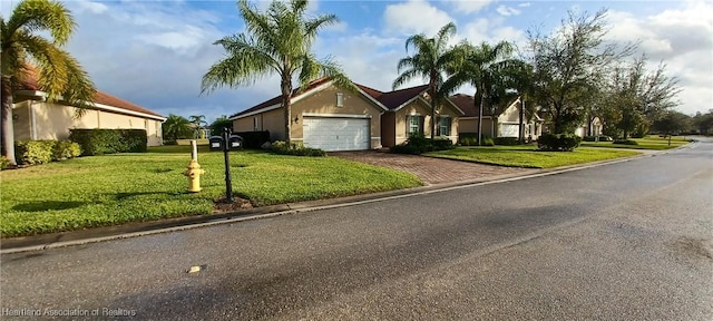 single story home with a front lawn and a garage