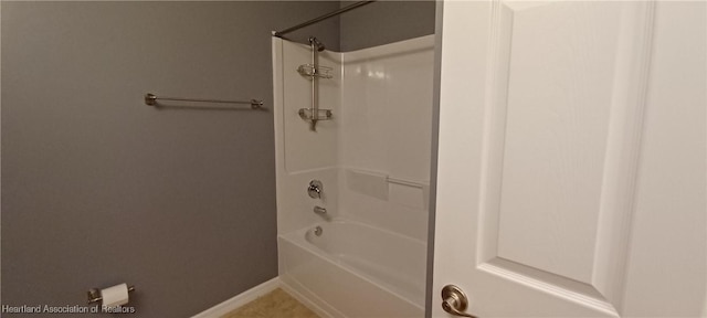 bathroom featuring tile patterned flooring and  shower combination