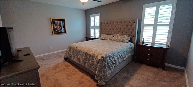 bedroom featuring carpet flooring, ceiling fan, and multiple windows