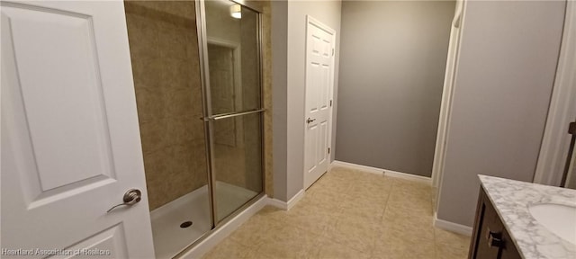 bathroom with a shower with door and vanity