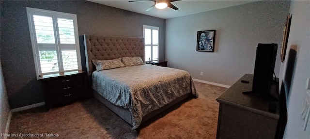 carpeted bedroom featuring ceiling fan and multiple windows