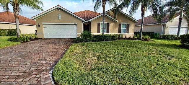 ranch-style home with a garage and a front lawn