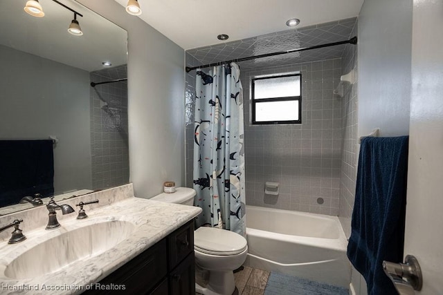 full bathroom featuring vanity, toilet, and shower / bathtub combination with curtain