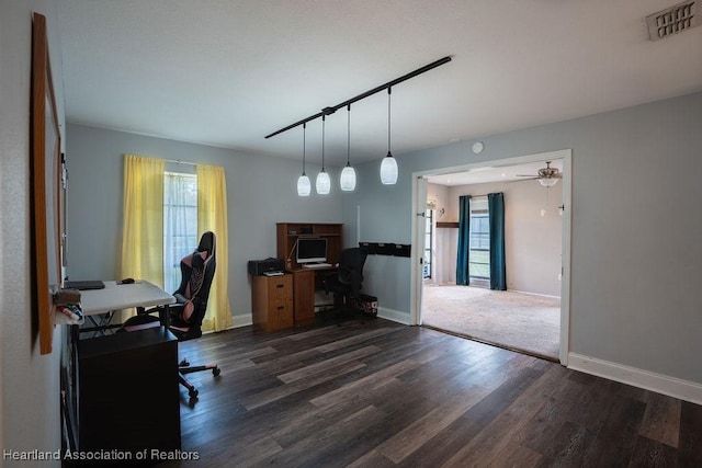 office area with ceiling fan, dark wood-type flooring, and track lighting