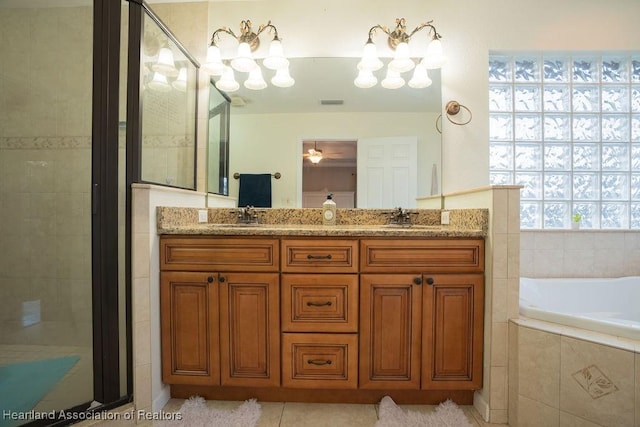 bathroom with tile patterned floors, vanity, and independent shower and bath