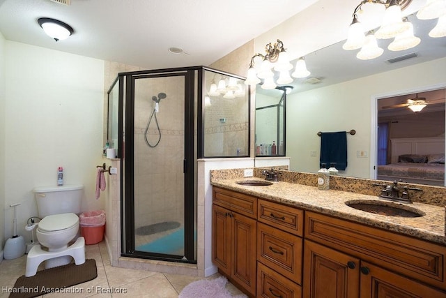 bathroom with vanity, tile patterned floors, ceiling fan, toilet, and an enclosed shower