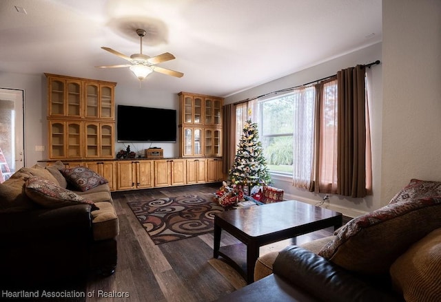 living room featuring dark hardwood / wood-style floors and ceiling fan