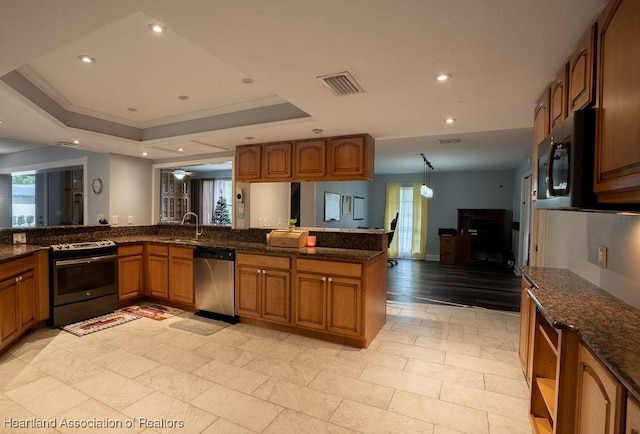 kitchen with kitchen peninsula, stainless steel dishwasher, a tray ceiling, dark stone countertops, and black electric range