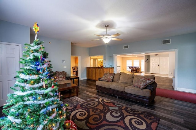 living room featuring dark hardwood / wood-style floors and ceiling fan