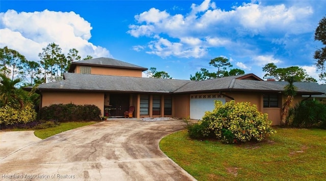 view of front of house with a garage and a front yard