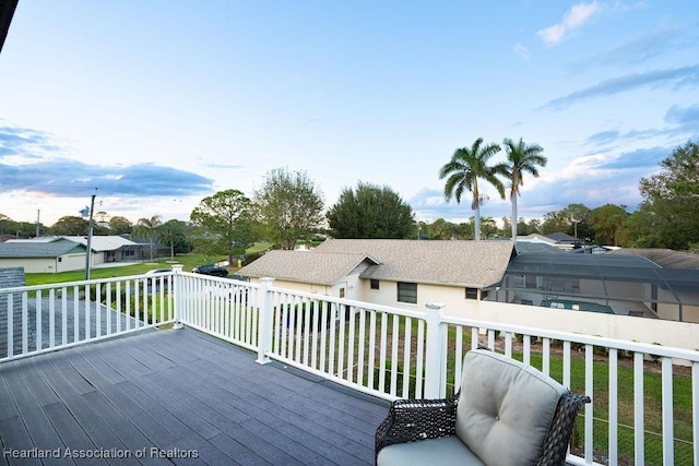 wooden deck featuring a lawn